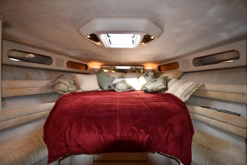 Slide: The Image of Luxurious cabin interior of 1995 Sea Ray 630 Sundancer with cozy bedding and ambient lighting. - 41