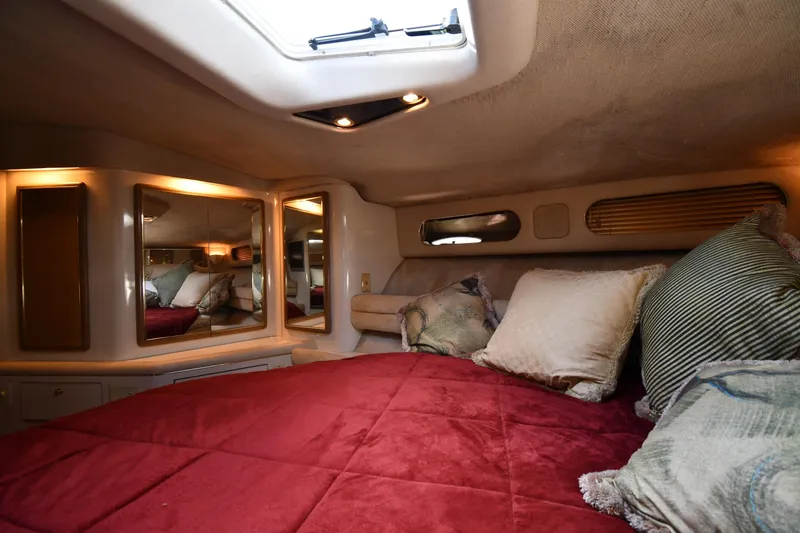 Slide: The Image of Luxurious 1995 Sea Ray 630 Sundancer cabin with plush bedding and elegant lighting. - 44