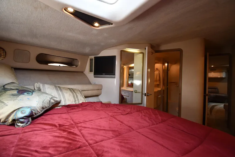 Slide: The Image of Luxurious cabin interior of 1995 Sea Ray 630 Sundancer yacht with red bedding. - 45