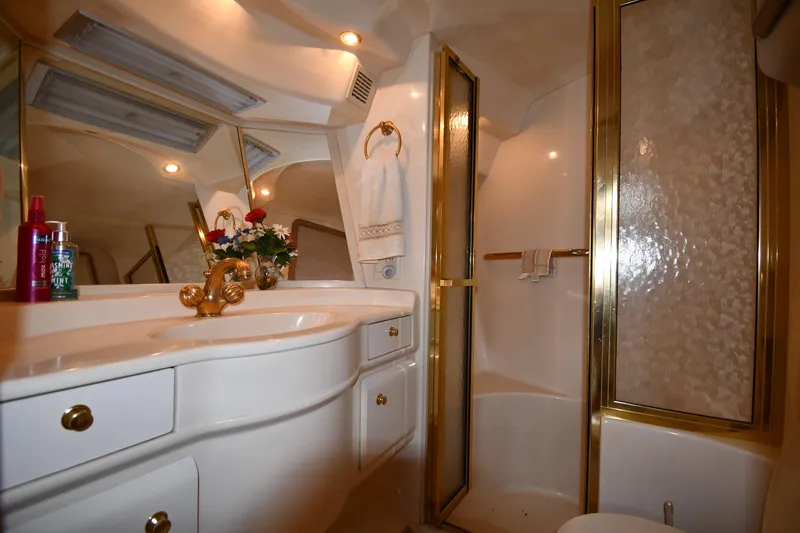 Slide: The Image of Luxurious bathroom interior of 1995 Sea Ray 630 Sundancer yacht with gold accents. - 47
