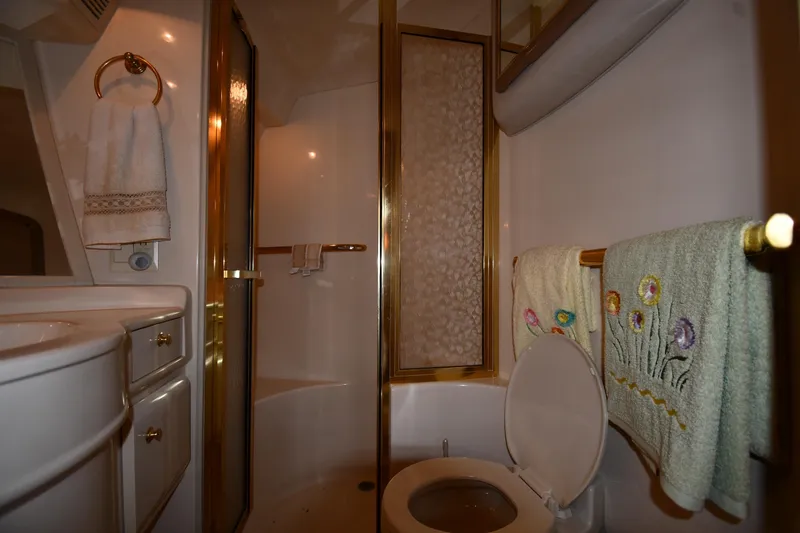 Slide: The Image of Bathroom interior of 1995 Sea Ray 630 Sundancer yacht with shower and decorative towels. - 48