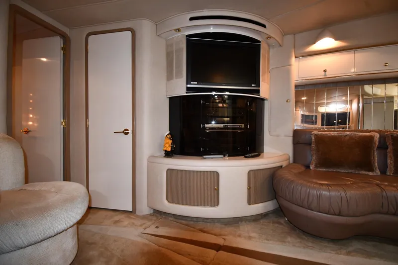 Slide: The Image of Luxurious interior of 1995 Sea Ray 630 Sundancer yacht with plush seating and entertainment center. - 54