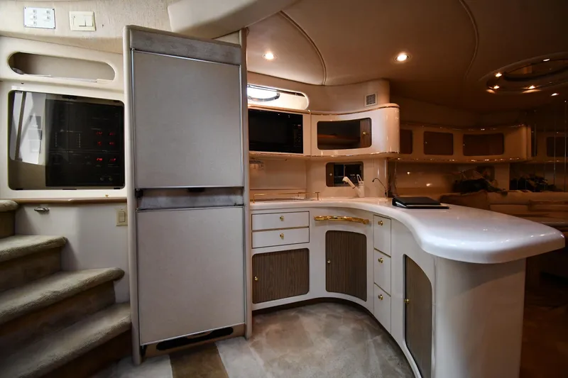 Slide: The Image of Luxurious interior of 1995 Sea Ray 630 Sundancer yacht with modern kitchen amenities. - 55