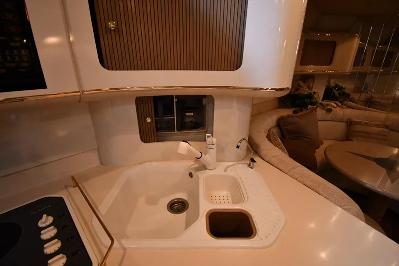 Slide: The Image of Luxurious kitchen area in 1995 Sea Ray 630 Sundancer yacht with sink and seating. - 56