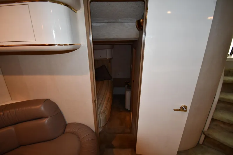 Slide: The Image of 1995 Sea Ray 630 Sundancer interior with beige seating and cabin entrance. - 62