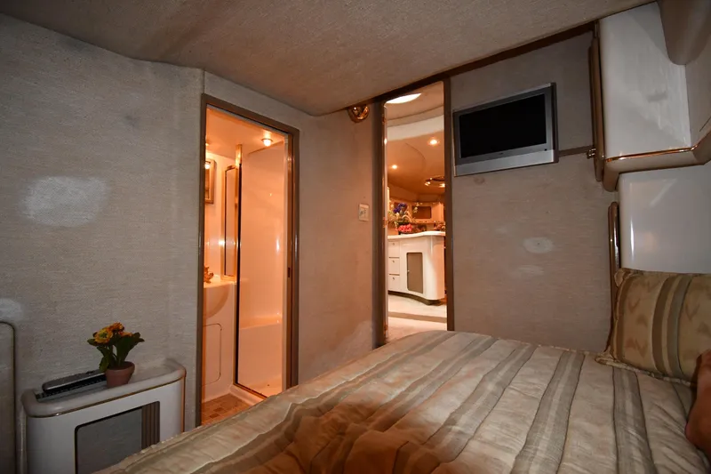 Slide: The Image of Interior of 1995 Sea Ray 630 Sundancer yacht with cozy bedroom and modern amenities. - 64