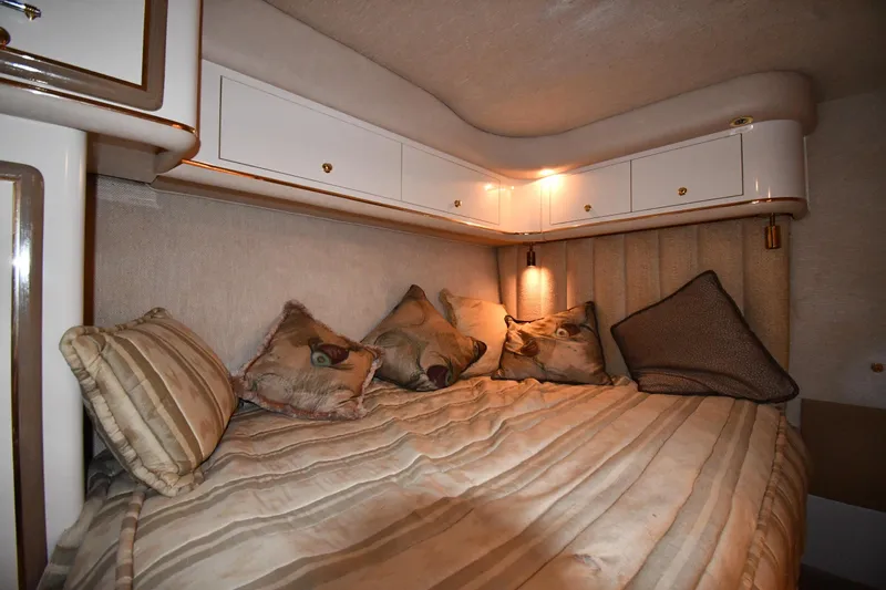 Slide: The Image of Cozy cabin interior of 1995 Sea Ray 630 Sundancer with plush bedding and ambient lighting. - 66