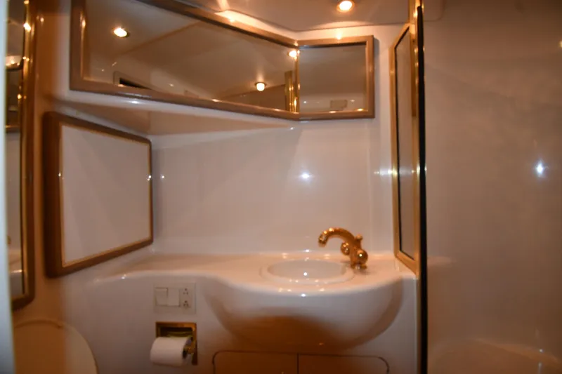 Slide: The Image of Luxurious bathroom interior of 1995 Sea Ray 630 Sundancer yacht with gold fixtures. - 68