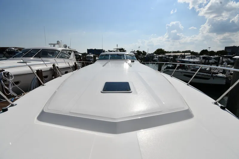 Slide: The Image of 1995 Sea Ray 630 Sundancer yacht docked at marina under clear sky. - 7