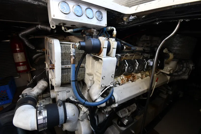 Slide: The Image of Engine room of a 1995 Sea Ray 630 Sundancer yacht, showcasing detailed machinery. - 74
