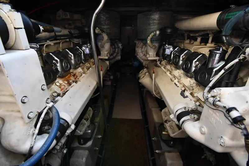 Slide: The Image of Engine room of 1995 Sea Ray 630 Sundancer yacht, showcasing dual engines and mechanical components. - 75