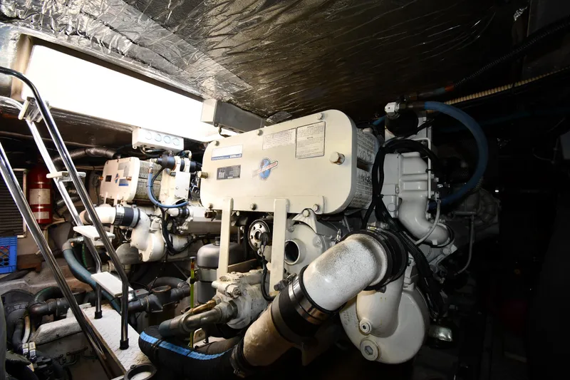 Slide: The Image of Engine room of 1995 Sea Ray 630 Sundancer yacht with visible machinery and equipment. - 76