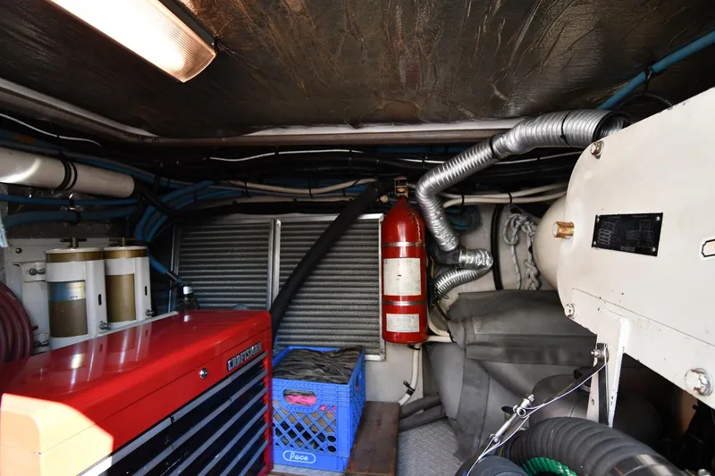 Slide: The Image of Engine room of 1995 Sea Ray 630 Sundancer with fire extinguisher and equipment. - 78