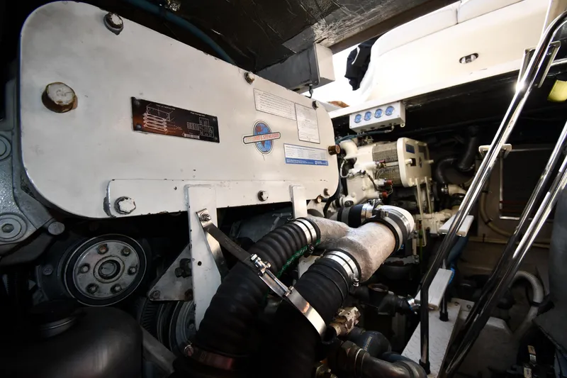 Slide: The Image of Engine room of 1995 Sea Ray 630 Sundancer yacht, showcasing mechanical components and equipment. - 80