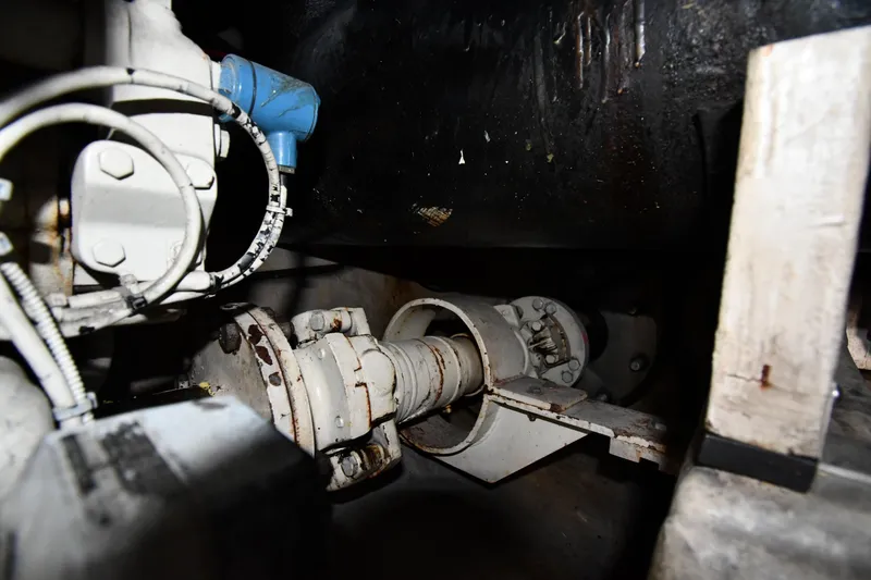 Slide: The Image of Engine room of 1995 Sea Ray 630 Sundancer, showcasing mechanical components and piping. - 82