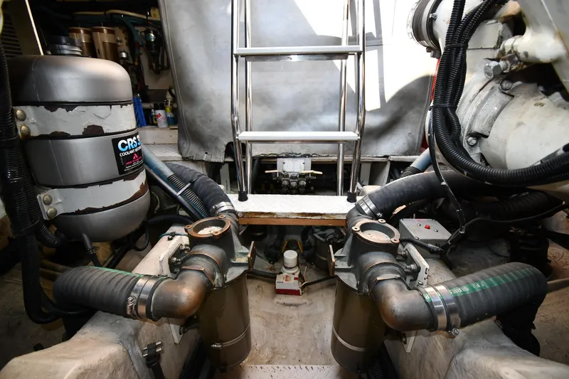 Slide: The Image of Engine room of 1995 Sea Ray 630 Sundancer with visible components and ladder. - 84