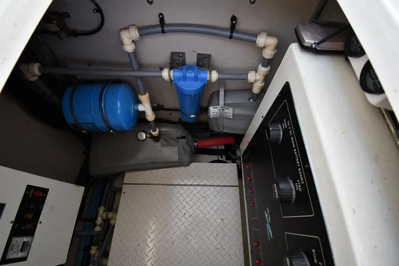 Slide: The Image of Engine room of 1995 Sea Ray 630 Sundancer with control panel and plumbing components. - 87