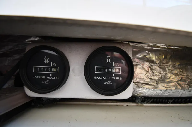 Slide: The Image of Engine hour meters on a 1995 Sea Ray 630 Sundancer boat dashboard. - 89