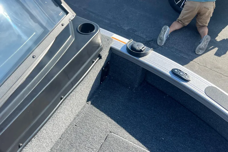 Slide: The Image of 2026 Crestliner 2050 Fish Hawk boat interior with carpeted deck and cup holder. - 12