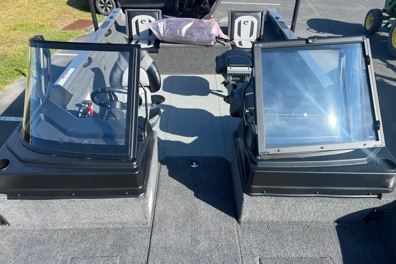 Slide: The Image of 2026 Crestliner 2050 Fish Hawk interior with dual consoles and seating. - 16