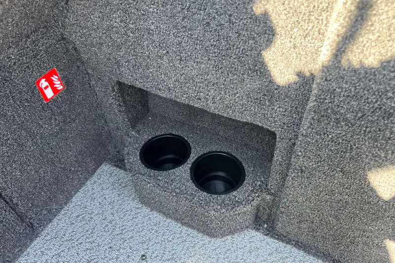 Slide: The Image of 2026 Crestliner 2050 Fish Hawk interior with dual cup holders and fire extinguisher symbol. - 27