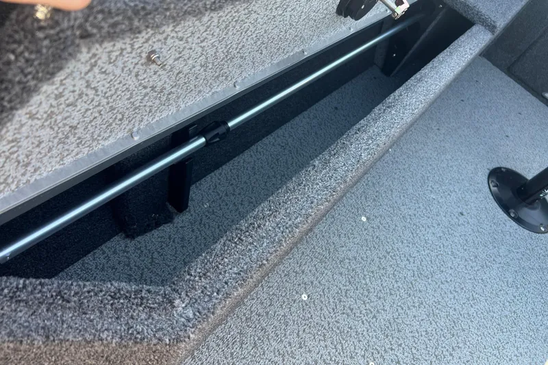 Slide: The Image of 2026 Crestliner 2050 Fish Hawk interior storage compartment with textured flooring. - 28