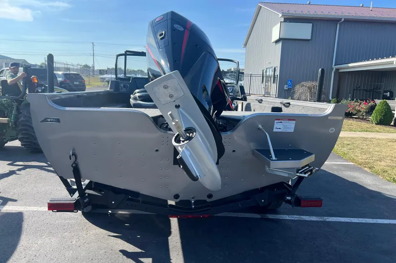 Slide: The Image of 2026 Crestliner 2050 Fish Hawk boat with powerful outboard motor, parked outdoors. - 3