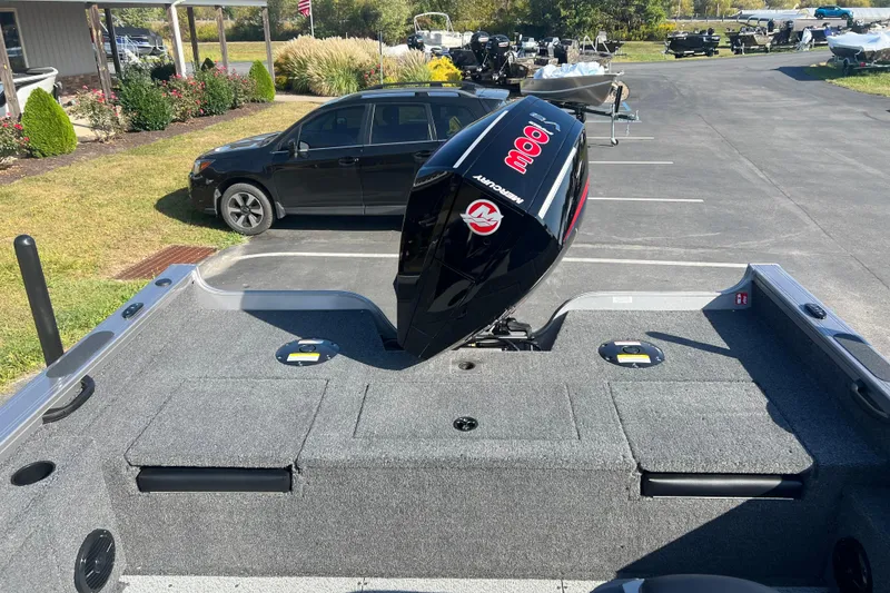 Slide: The Image of 2026 Crestliner 2050 Fish Hawk boat with Mercury engine, parked outdoors on a sunny day. - 30