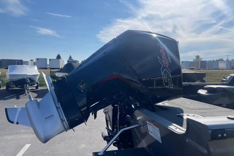Slide: The Image of 2026 Crestliner 2050 Fish Hawk with Mercury Pro XS outboard motor in a parking lot. - 4