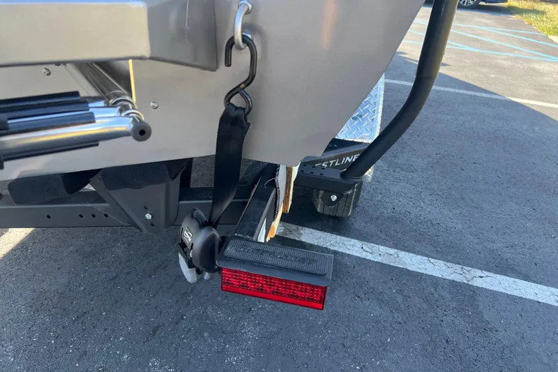 Slide: The Image of Rear view of 2026 Crestliner 2050 Fish Hawk boat trailer with safety strap and light. - 6