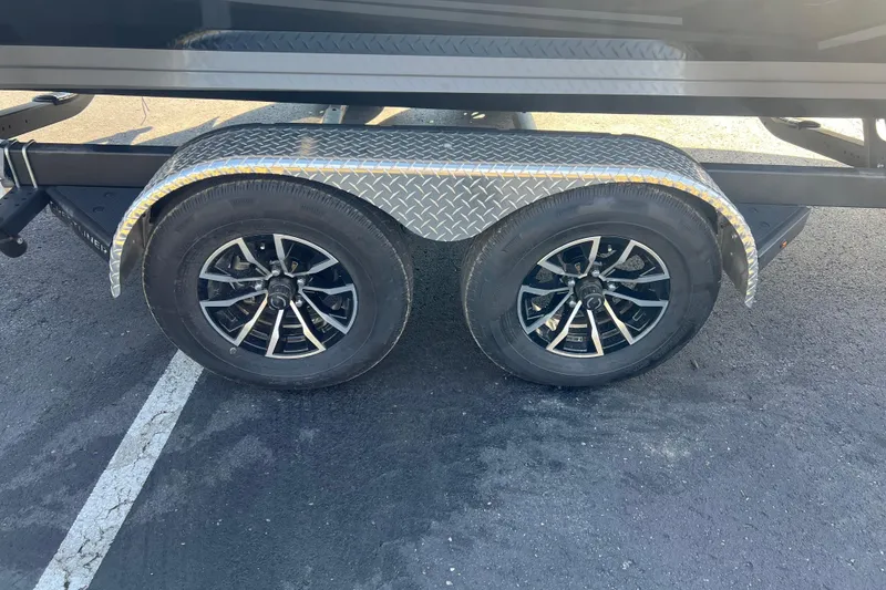 Slide: The Image of Trailer wheels of 2026 Crestliner 2050 Fish Hawk on asphalt surface. - 7