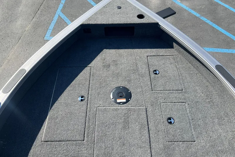 Slide: The Image of 2026 Crestliner 2050 Fish Hawk boat deck with storage compartments and carpeted surface. - 9