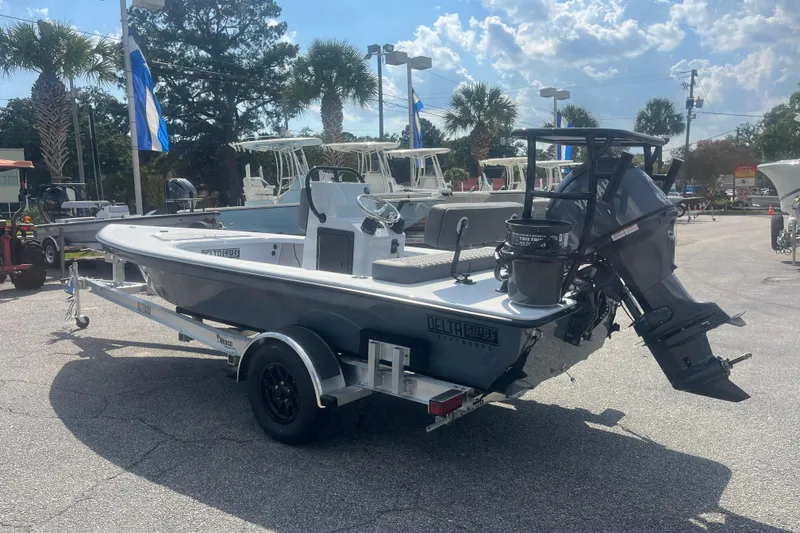 Slide: The Image of 2026 Delta Boatworks D18 on trailer, displayed outdoors at a boat dealership. - 1