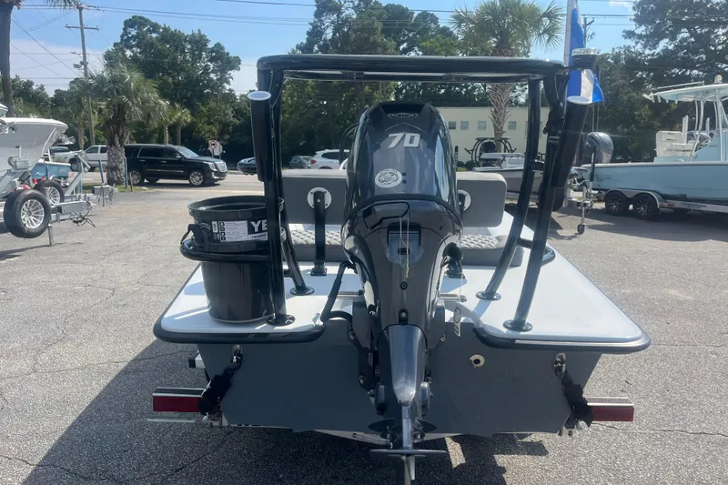 Slide: The Image of 2026 Delta Boatworks D18 on trailer, outdoor display with palm trees and blue sky. - 2