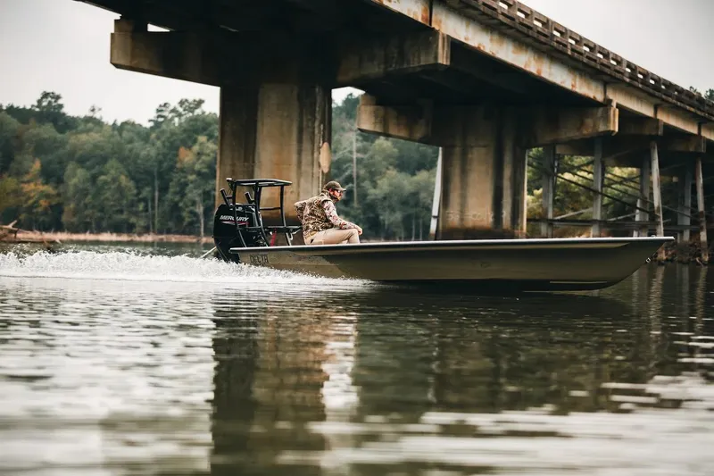 Slide: The Image of 2026 Delta Boatworks D-18 cruising under a bridge on a calm river. - 9