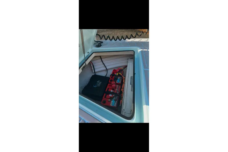 Slide: The Image of Open storage compartment in 2019 Maverick 18 HPX-V boat with equipment inside. - 6