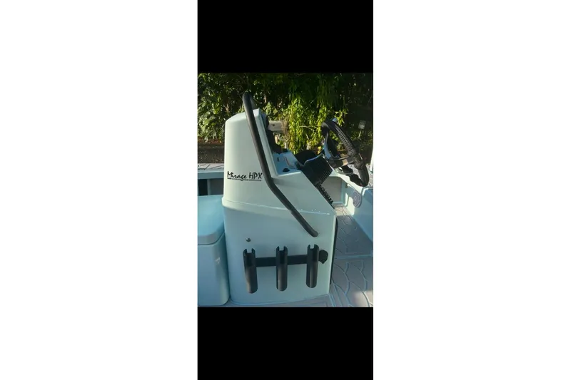Slide: The Image of 2019 Maverick 18 HPX-V boat console with steering wheel and rod holders. - 7