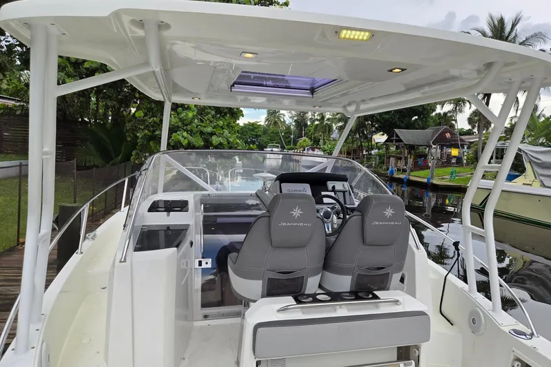 Slide: The Image of 2020 Jeanneau Leader 9.0 WA boat interior with helm, seats, and canopy. - 12
