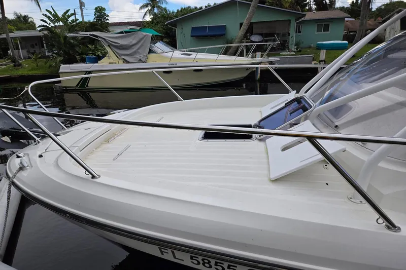 Slide: The Image of 2020 Jeanneau Leader 9.0 WA boat docked near a canal-side house. - 8