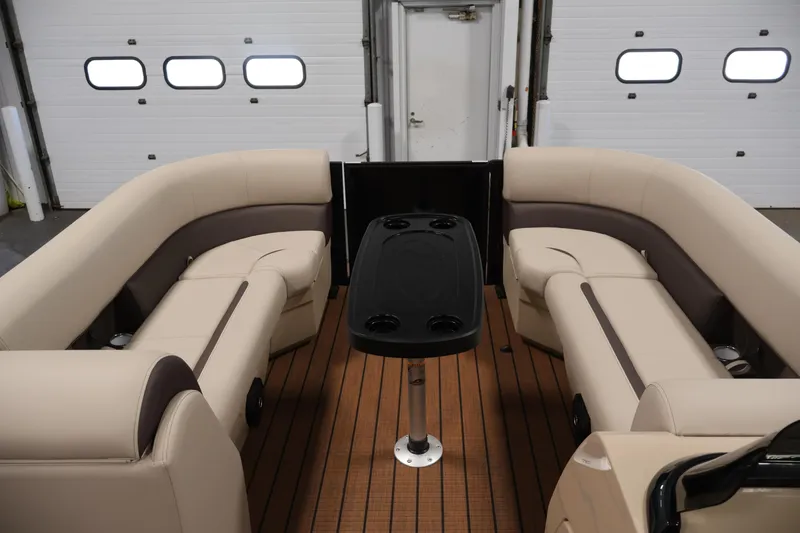 Slide: The Image of 2026 Bentley Pontoons 243 Swingback Tri-toon interior with beige seating and central table. - 10