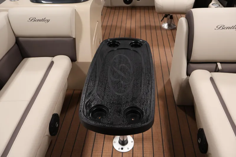 Slide: The Image of Interior of 2026 Bentley Pontoons 243 Swingback Tri-toon with elegant seating and table. - 16