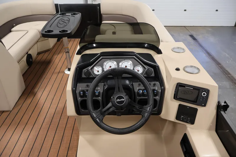 Slide: The Image of 2026 Bentley Pontoons 243 Swingback Tri-toon dashboard with steering wheel and control panel. - 19
