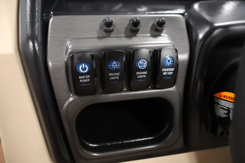 Slide: The Image of Control panel of 2026 Bentley Pontoons 243 Swingback Tri-toon with labeled switches. - 22