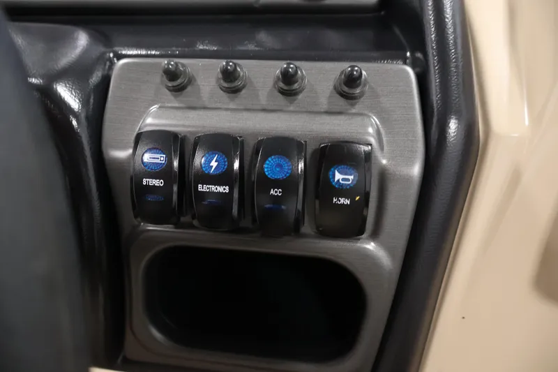 Slide: The Image of Control panel of 2026 Bentley Pontoons 243 Swingback Tri-toon with labeled switches. - 23