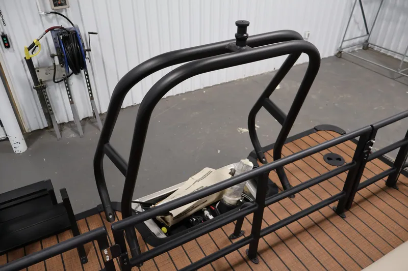 Slide: The Image of 2026 Bentley Pontoons 243 Swingback Tri-toon with sleek black railings and wood-textured flooring. - 32