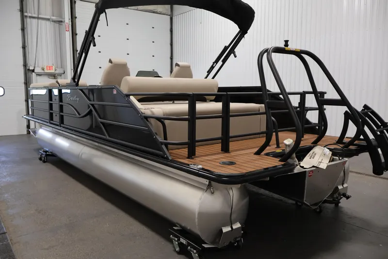 Slide: The Image of 2026 Bentley Pontoons 243 Swingback Tri-toon in a showroom, showcasing sleek design and luxury features. - 6