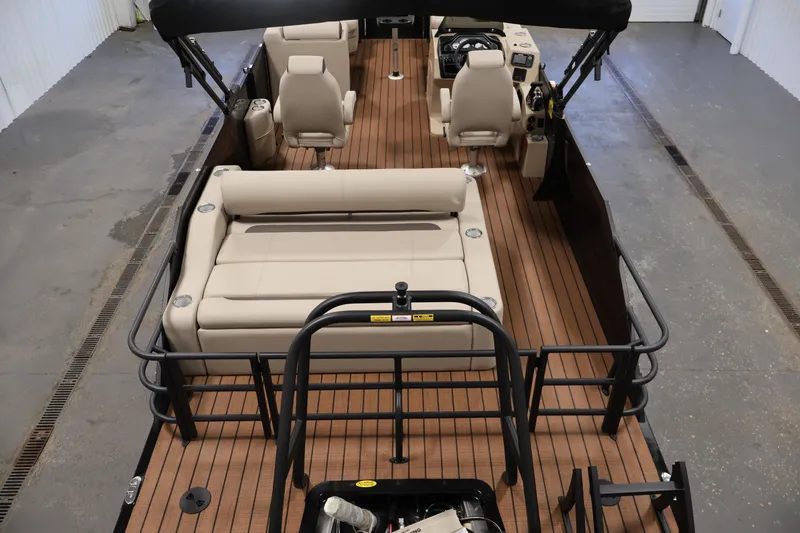Slide: The Image of 2026 Bentley Pontoons 243 Swingback Tri-toon interior with beige seating and wood-style flooring. - 9