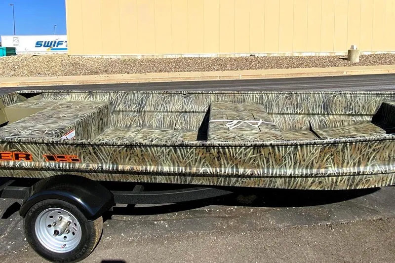 The Image of 2026 Tracker Grizzly 15 Jon boat with camouflage design on a trailer. - 0