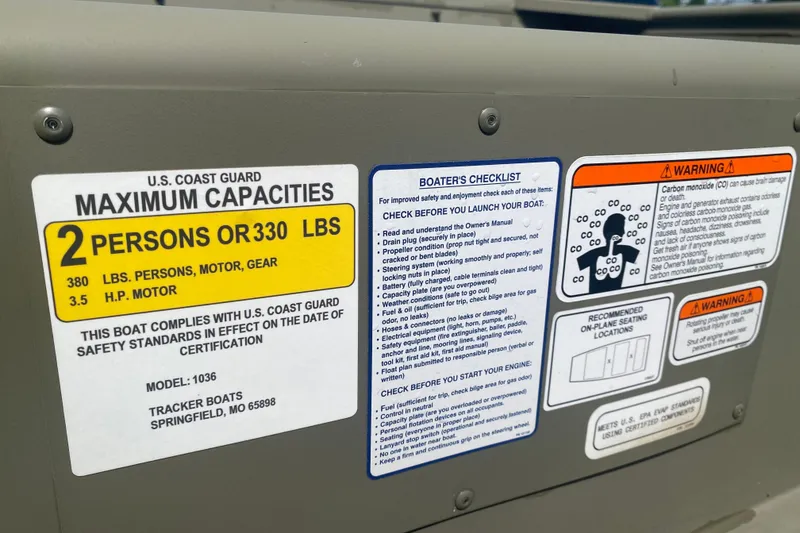 Slide: The Image of Tracker Grizzly 10 Jon 2026 boat capacity and safety labels with warnings and checklist. - 2