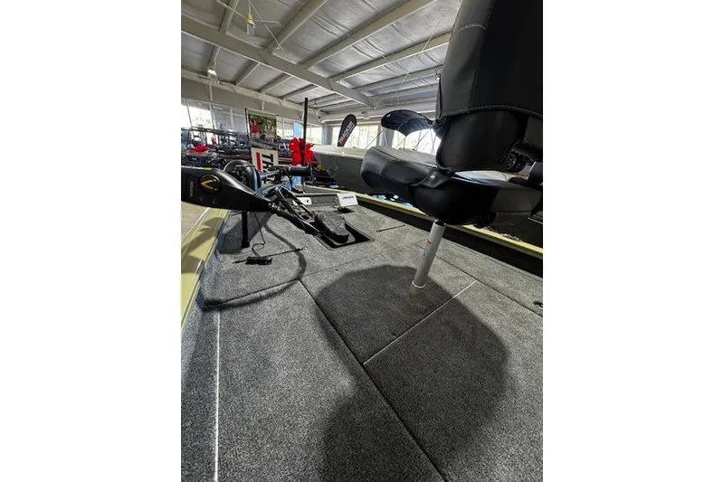 Slide: The Image of 2026 Tracker Pro Team 190 boat interior with seating and equipment in showroom. - 4